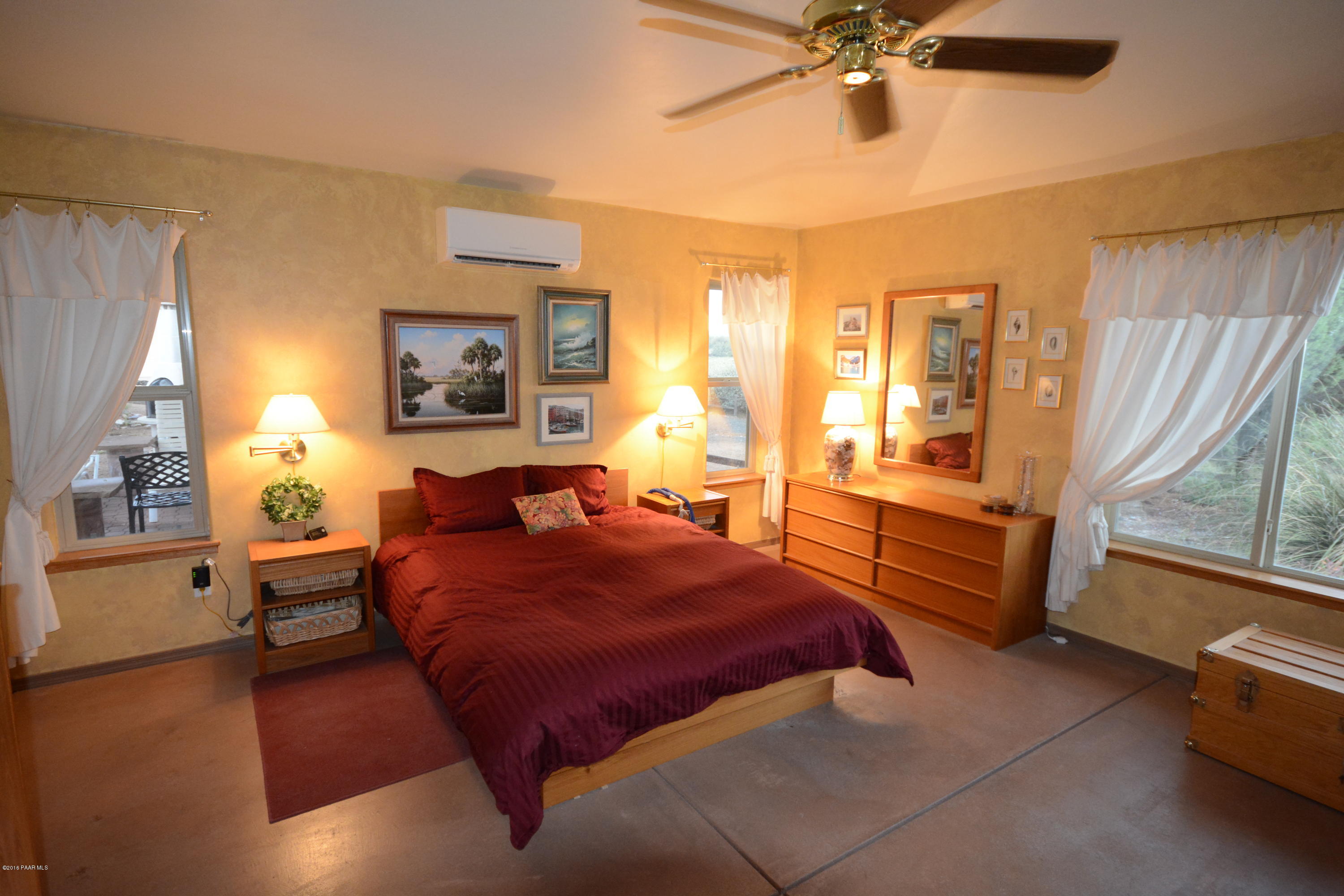 7200 Dillon Wash Road Prescott, AZ 86305 - Photo 26 of 47 a spacious bedroom with a bed and wooden floor