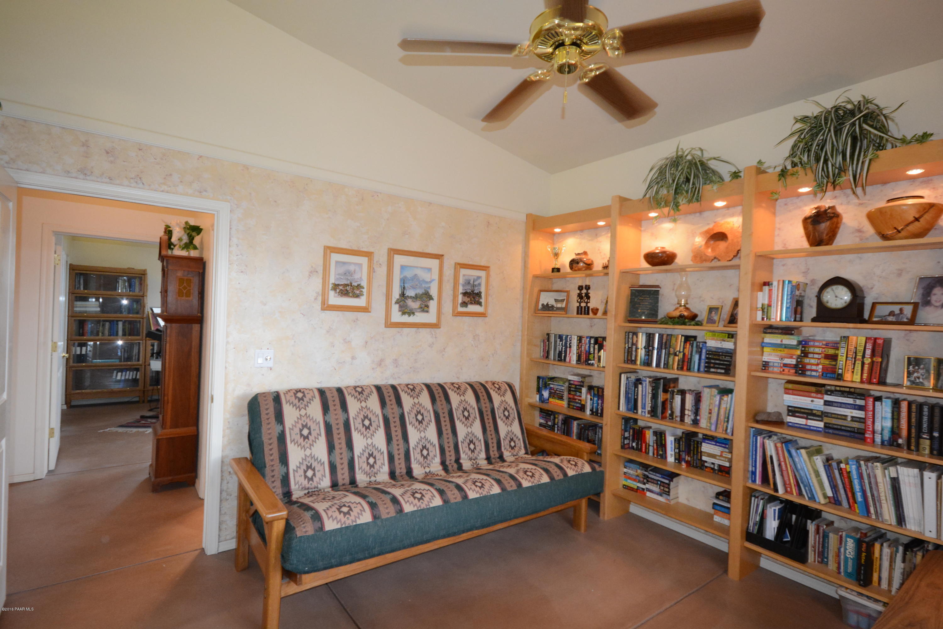 7200 Dillon Wash Road Prescott, AZ 86305 - Photo 30 of 47 a living room with lots of furniture and a book shelf