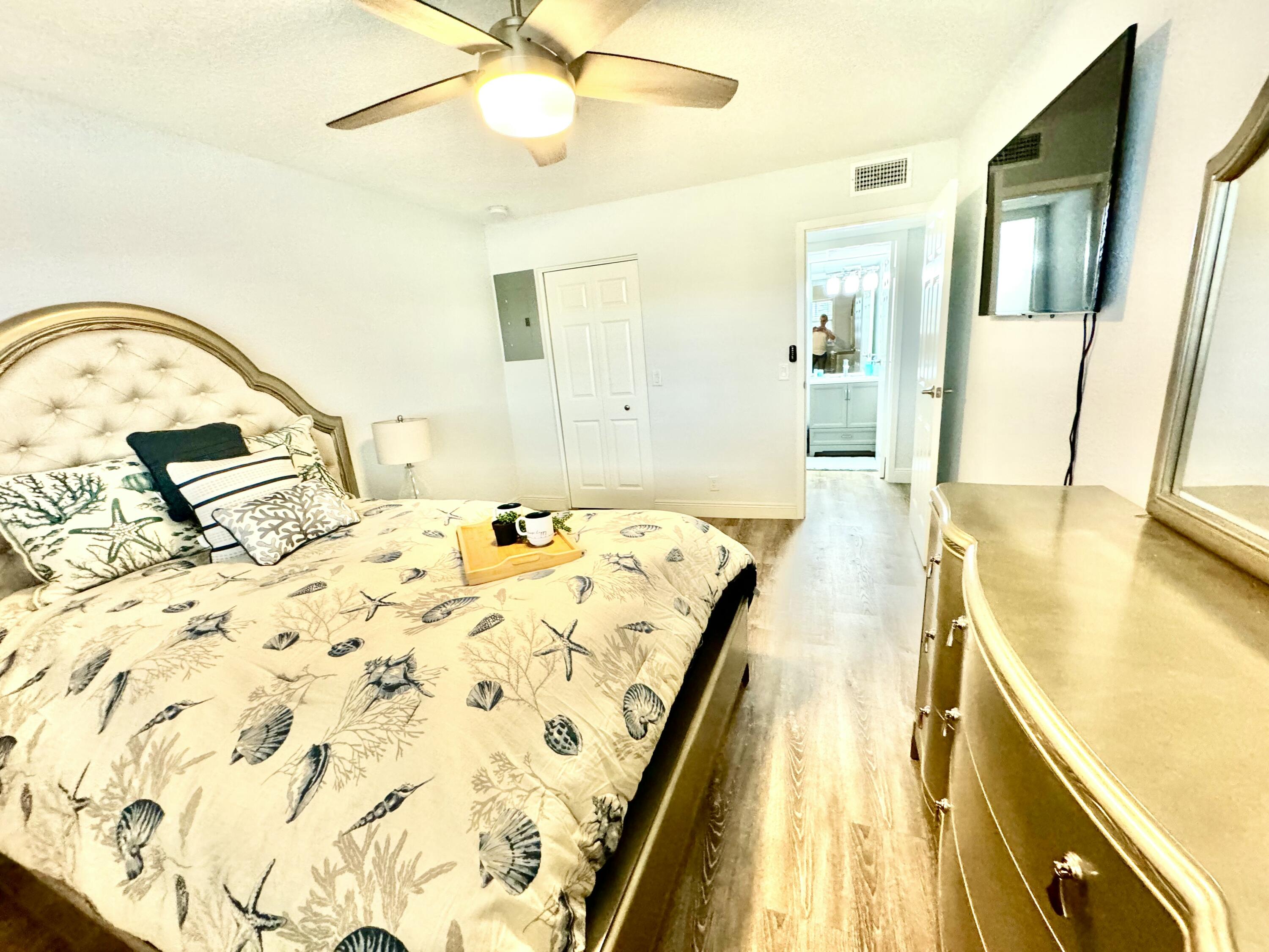 177 Brittany Terrace Delray Beach, FL 33446 - Photo 11 of 24 a view of a bedroom with a bed and wooden floor