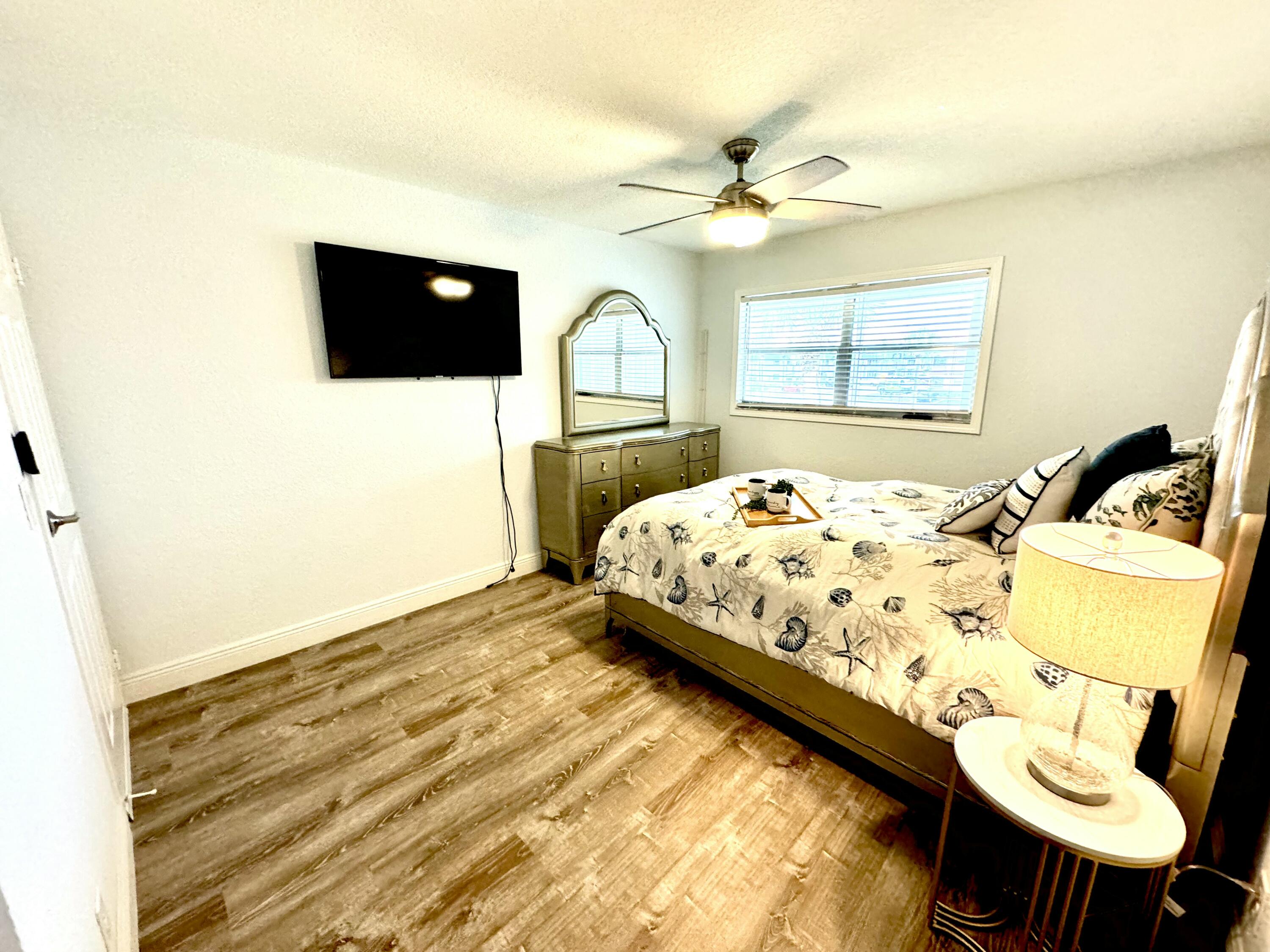 177 Brittany Terrace Delray Beach, FL 33446 - Photo 13 of 24 a bedroom with a bed and a flat screen tv