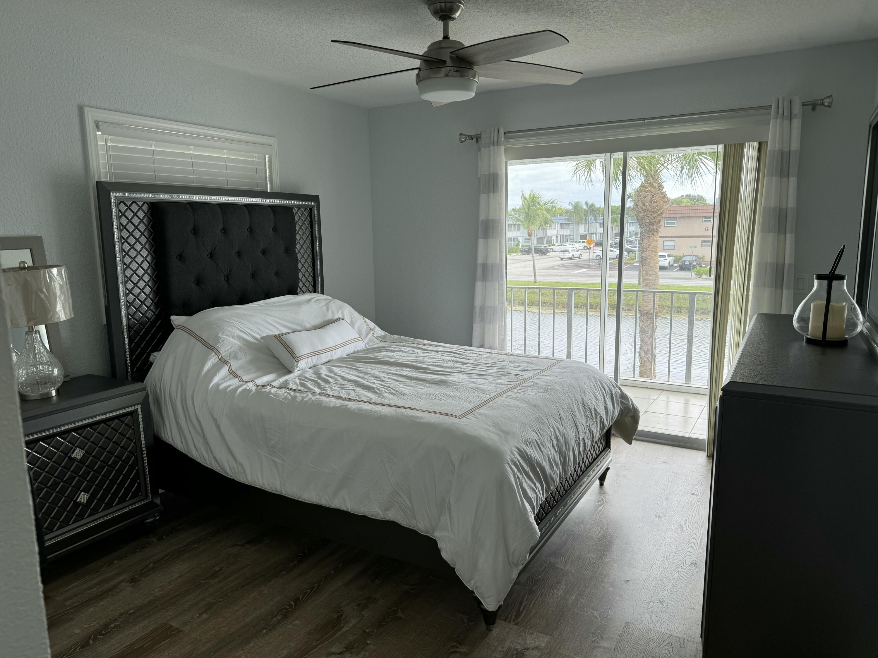 177 Brittany Terrace Delray Beach, FL 33446 - Photo 14 of 24 a bedroom with a bed and a large window