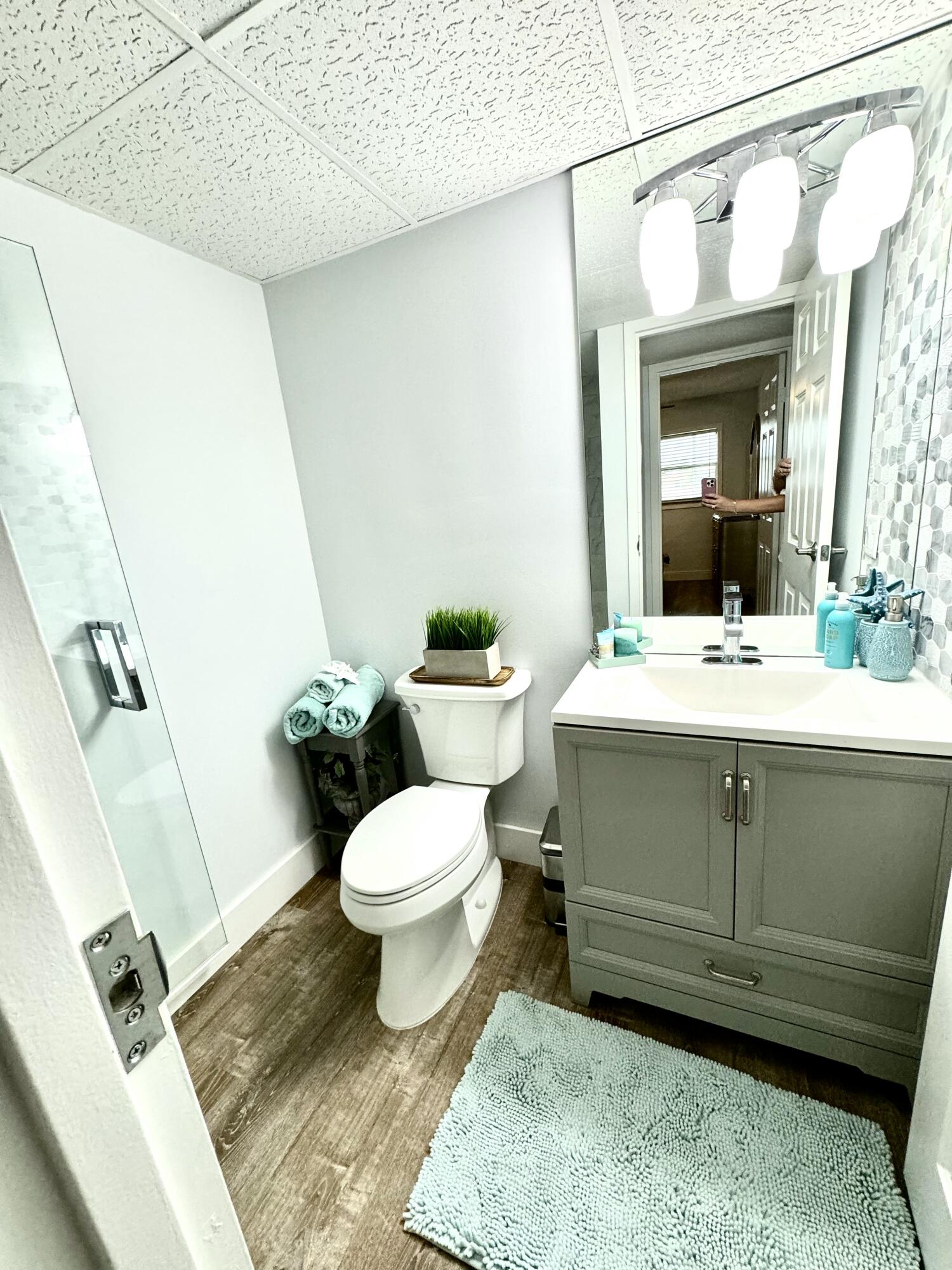 177 Brittany Terrace Delray Beach, FL 33446 - Photo 15 of 24 a bathroom with a sink mirror vanity and toilet