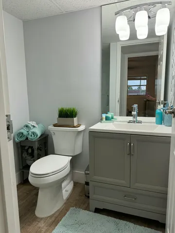 a bathroom with a toilet sink and mirror