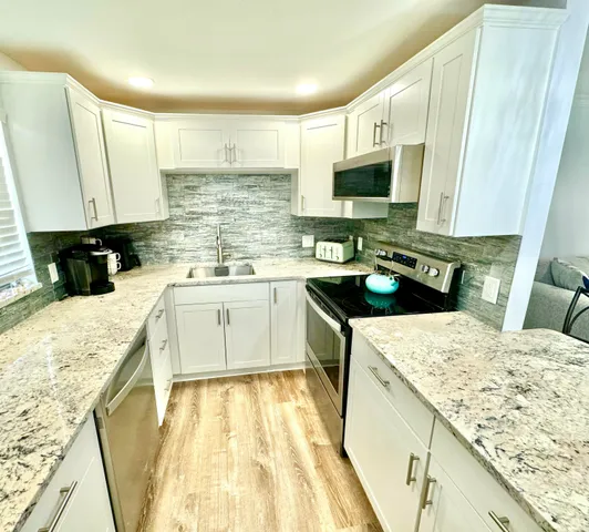 a kitchen with a sink stove and refrigerator