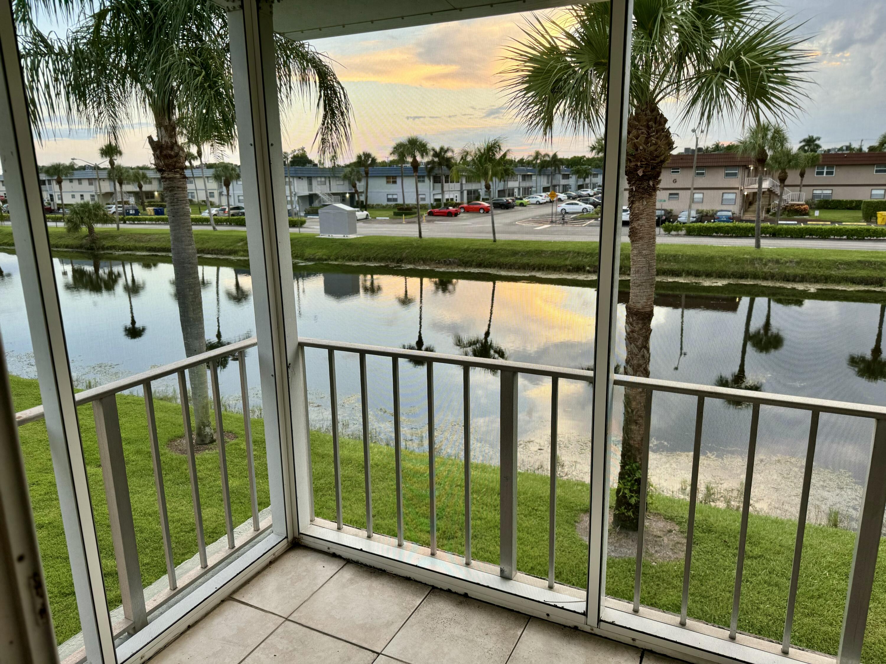177 Brittany Terrace Delray Beach, FL 33446 - Photo 24 of 24 a view of a balcony with floor to ceiling window and wooden fence