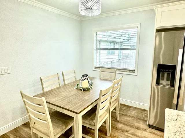 a view of a dining room with furniture and a window