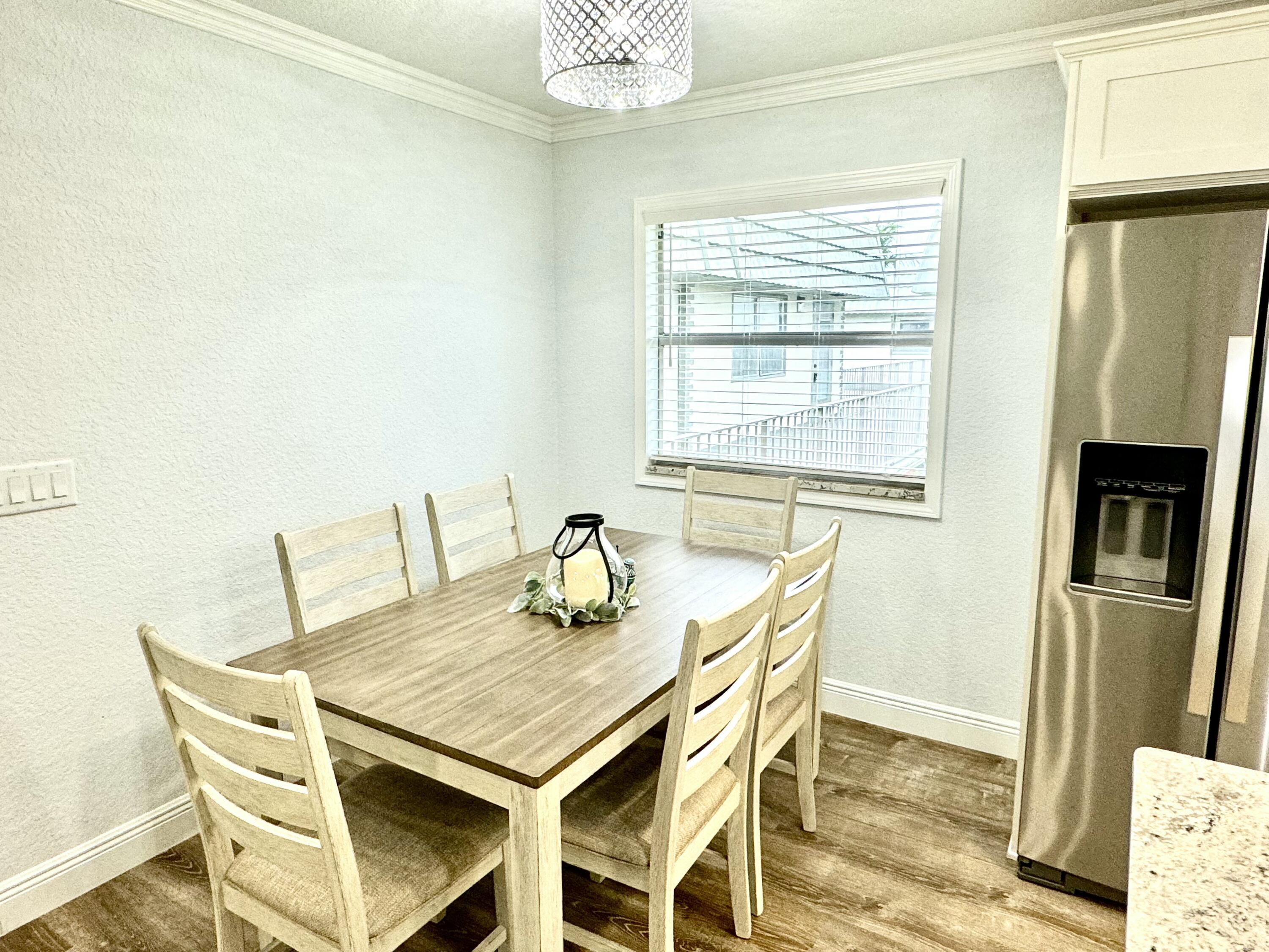 177 Brittany Terrace Delray Beach, FL 33446 - Photo 6 of 24 a view of a dining room with furniture and a window
