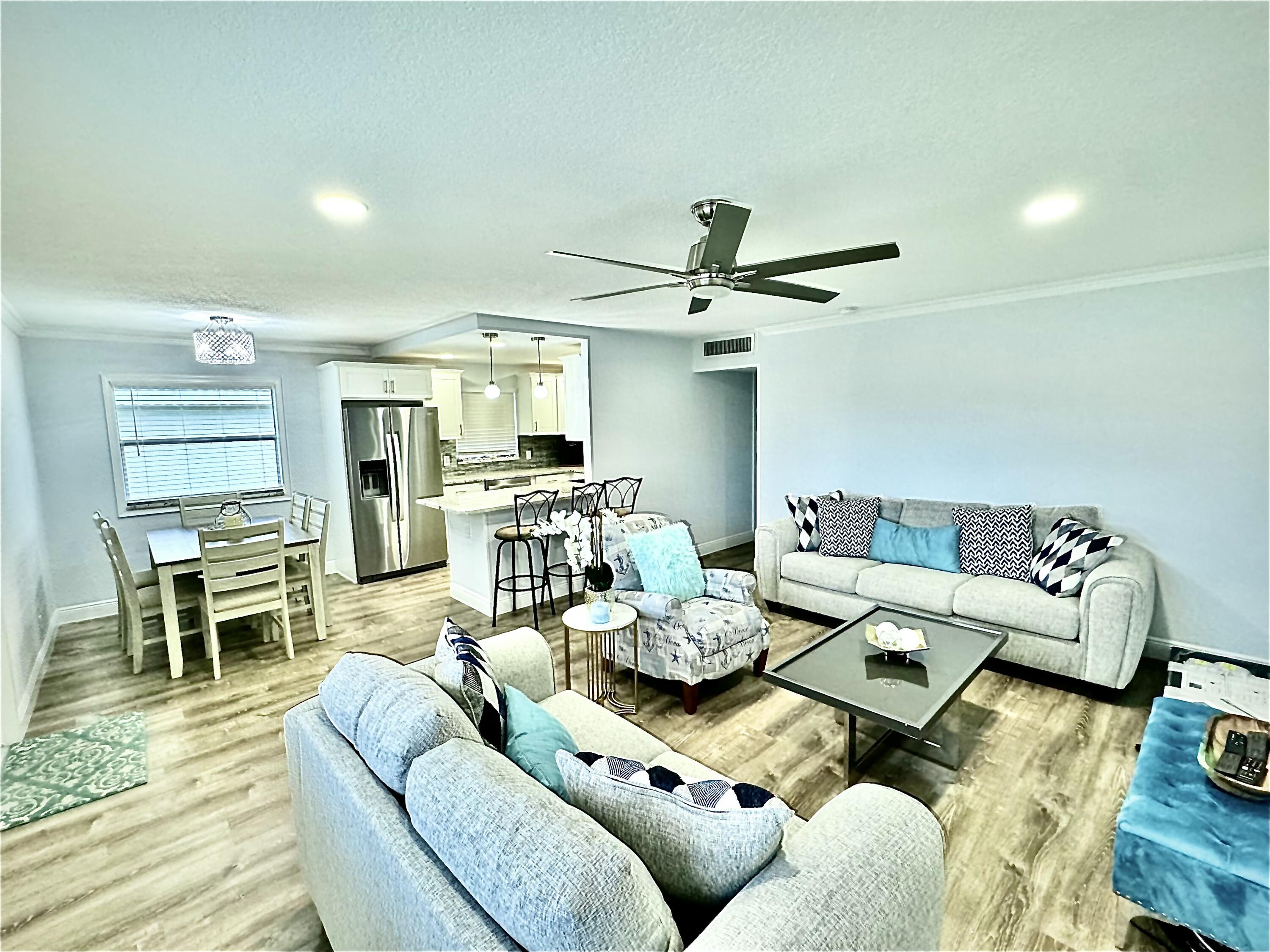 177 Brittany Terrace Delray Beach, FL 33446 - Photo 7 of 24 a living room with furniture kitchen view and a wooden floor