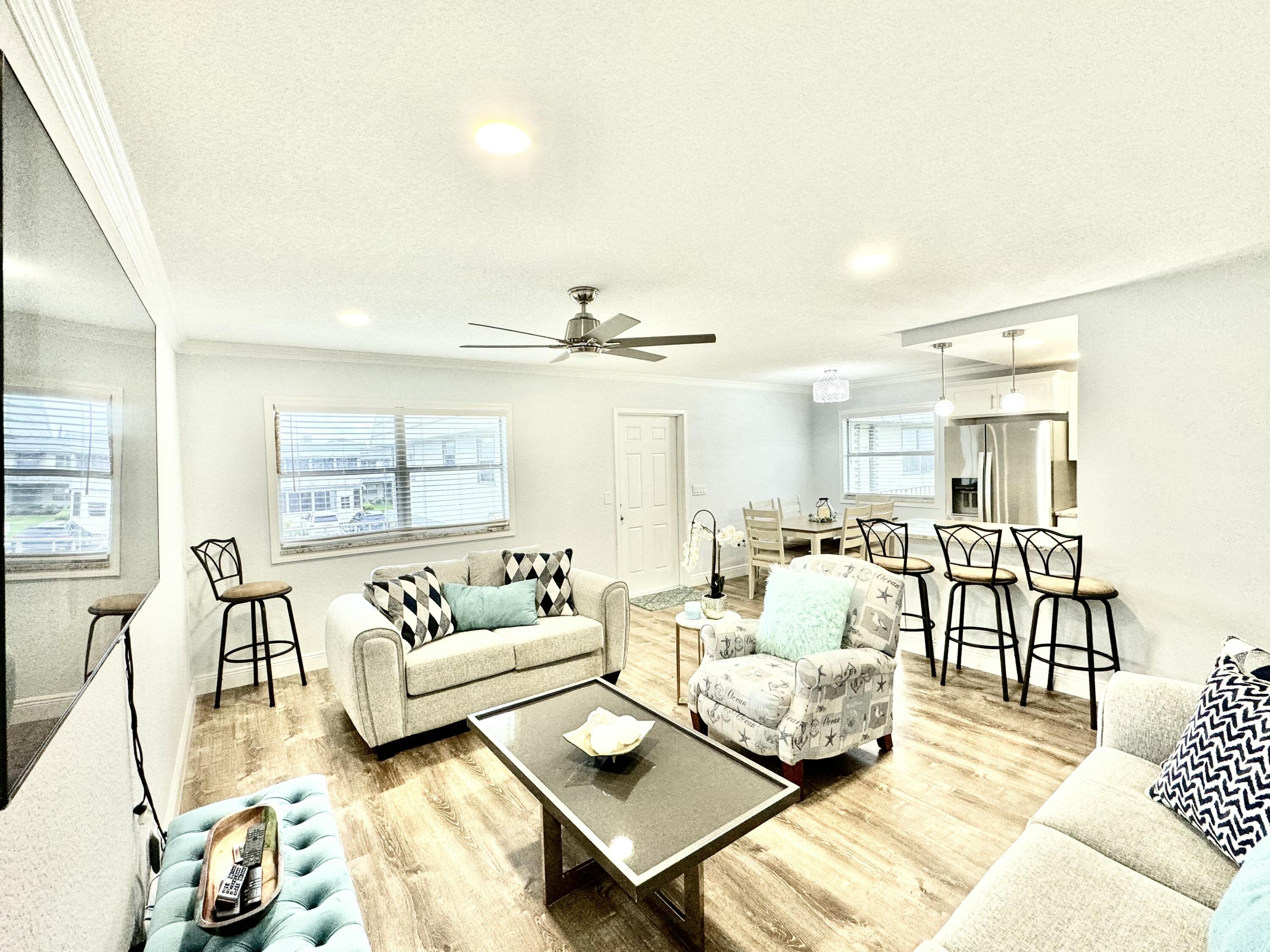 177 Brittany Terrace Delray Beach, FL 33446 - Photo 9 of 24 a living room with furniture and a large window