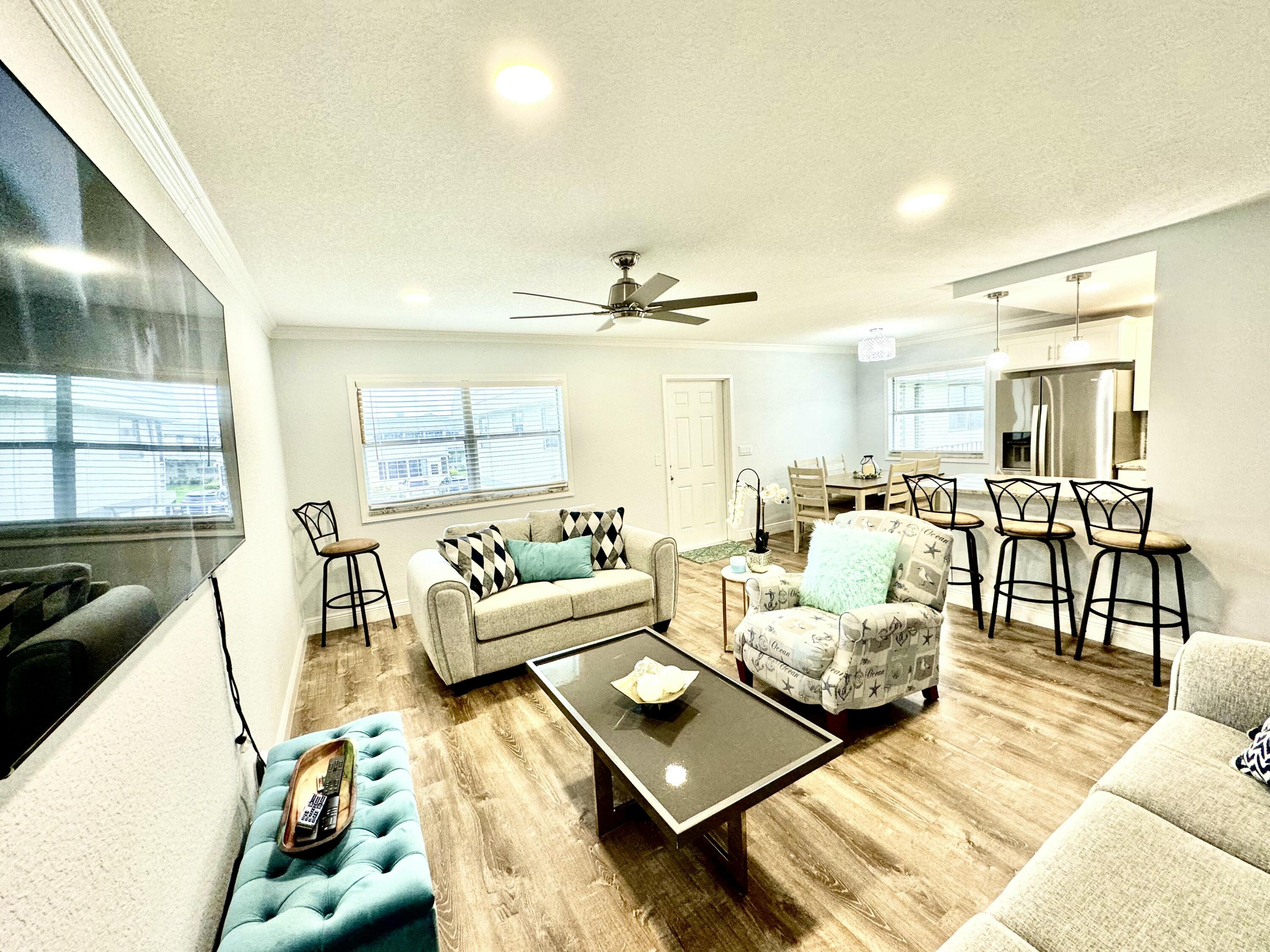177 Brittany Terrace Delray Beach, FL 33446 - Photo 10 of 24 a living room with furniture and a large window