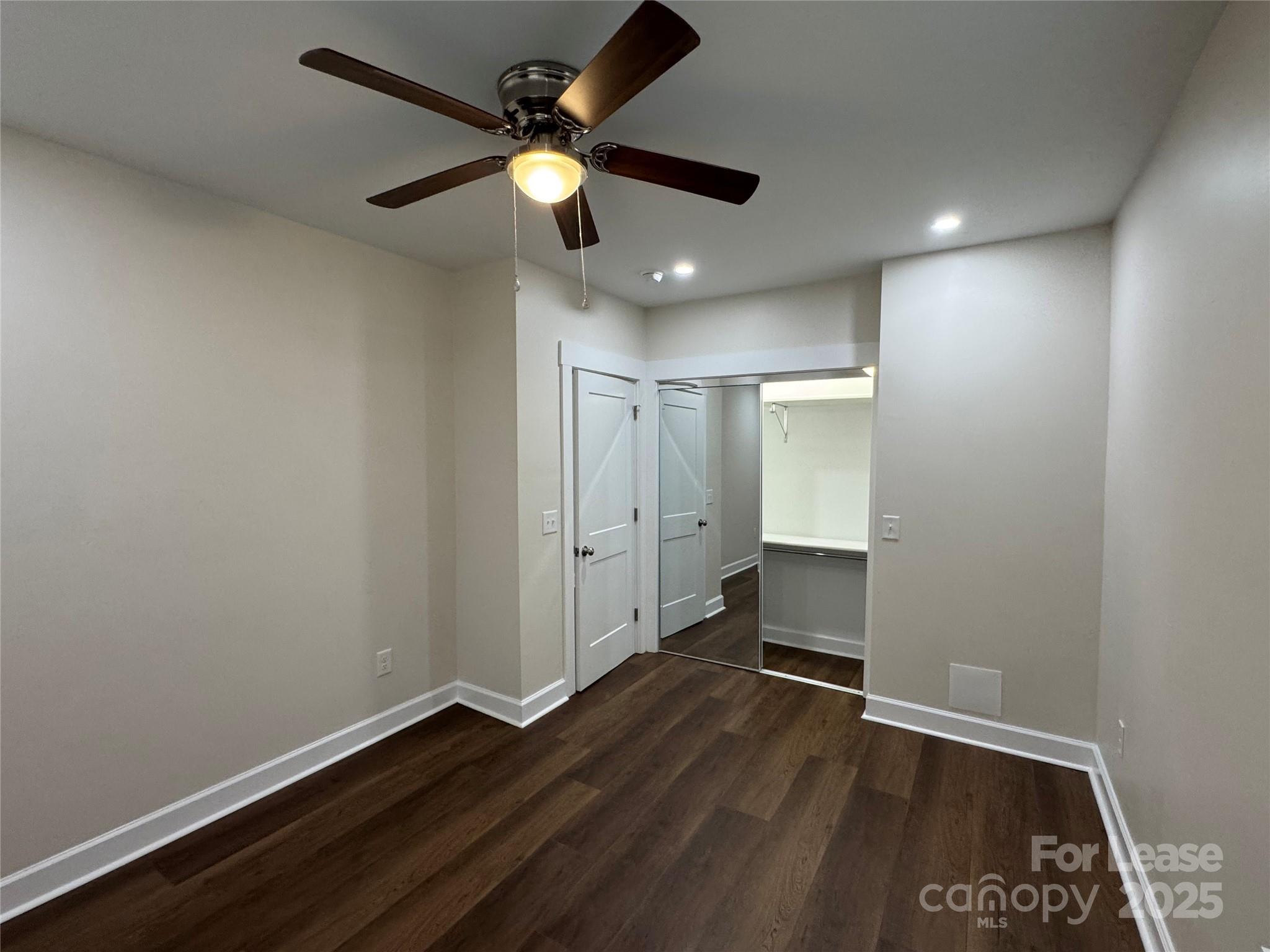 632 Graham Street Albemarle, NC 28001 - Photo 13 of 18 an empty room with wooden floor and windows