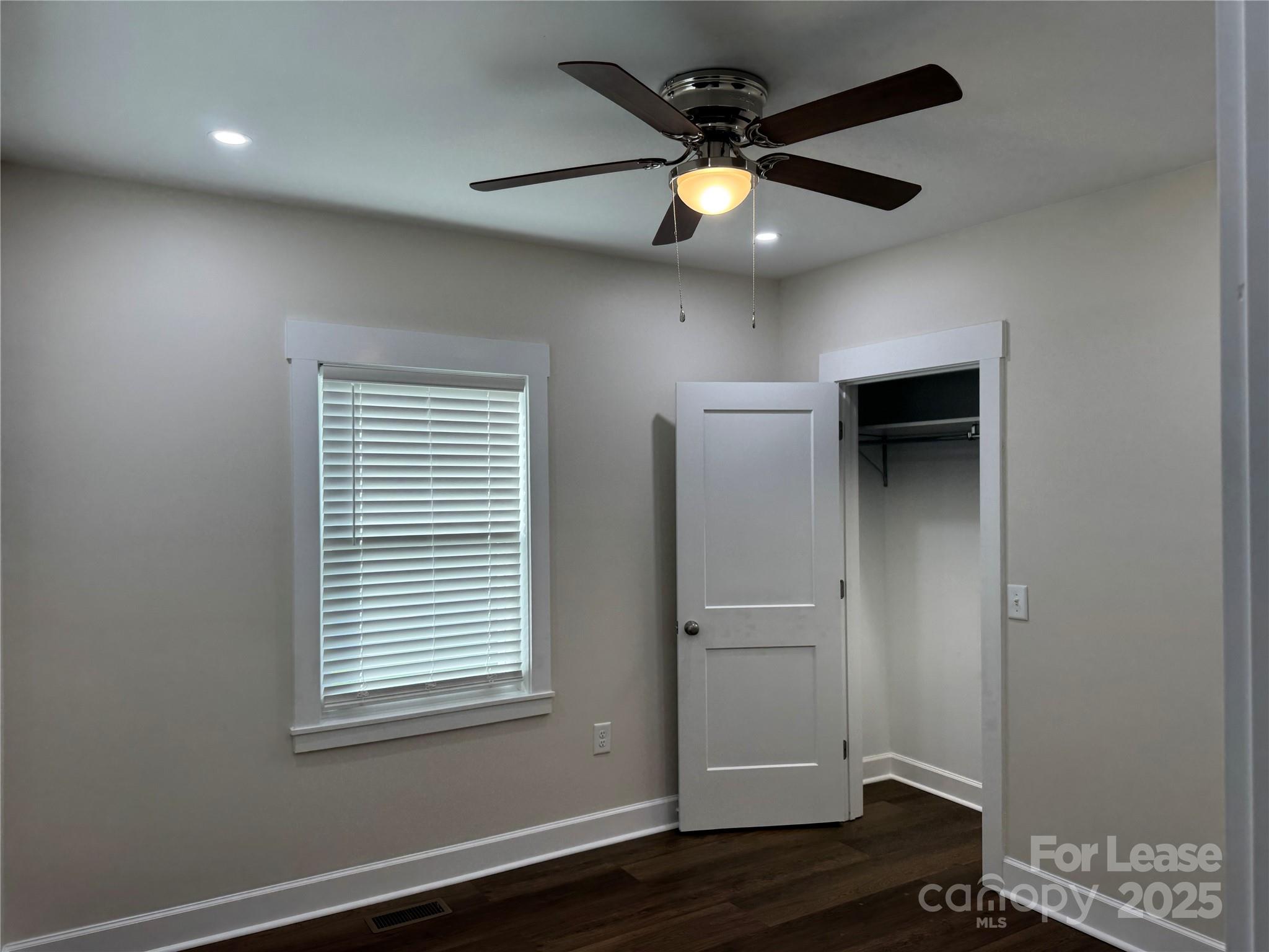 632 Graham Street Albemarle, NC 28001 - Photo 14 of 18 an empty room with wooden floor and windows