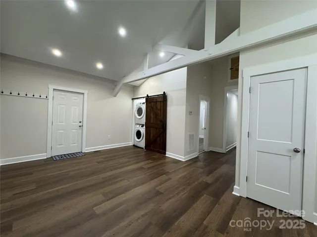 an empty room with wooden floor and closet