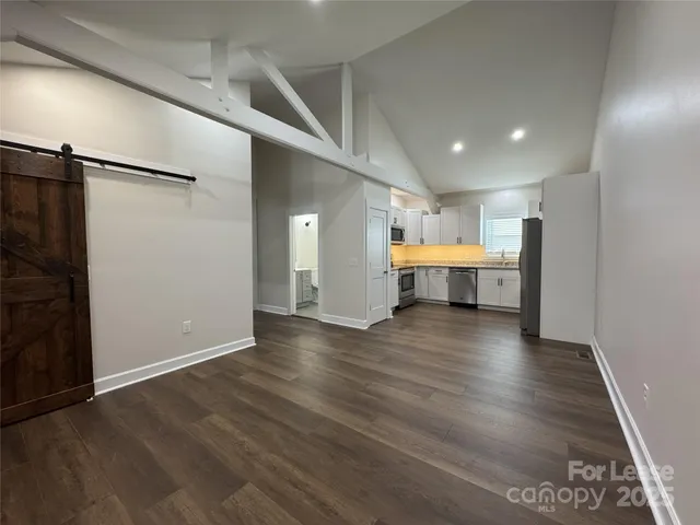 an empty room with wooden floor and fire place
