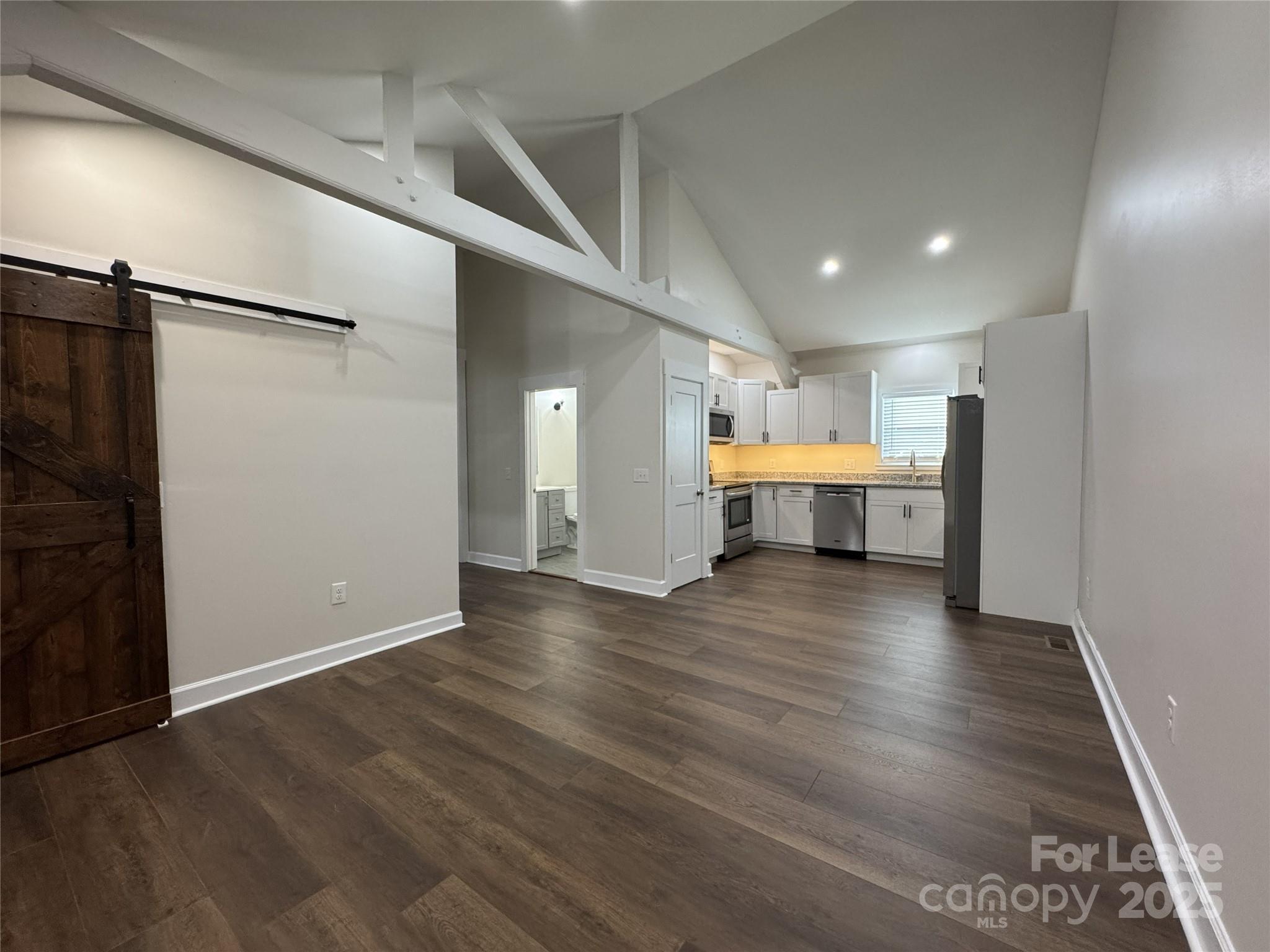 632 Graham Street Albemarle, NC 28001 - Photo 3 of 18 an empty room with wooden floor and fire place