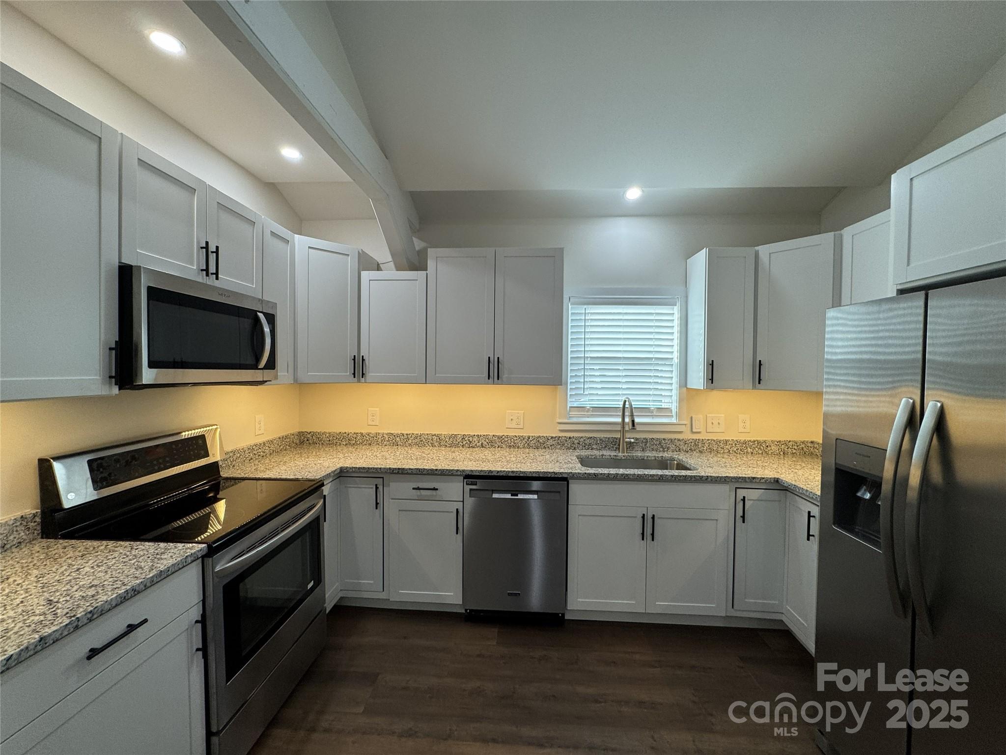 632 Graham Street Albemarle, NC 28001 - Photo 5 of 18 a kitchen with granite countertop a sink and steel appliances