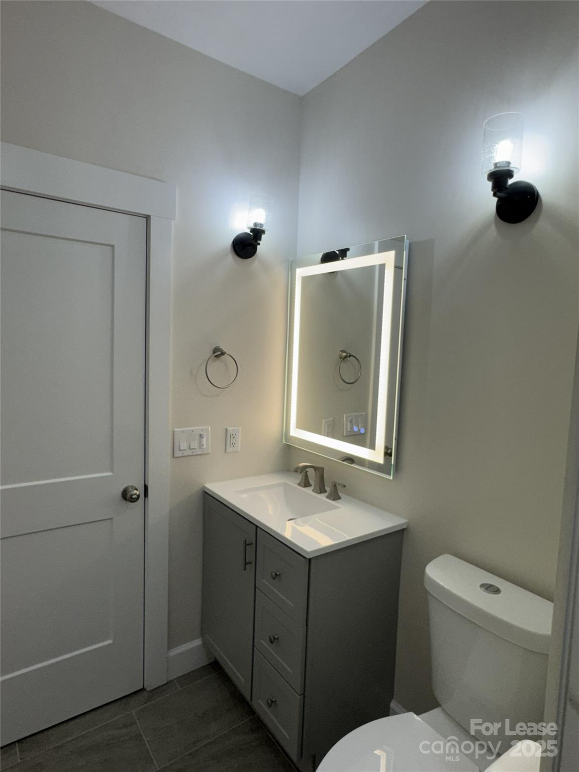 632 Graham Street Albemarle, NC 28001 - Photo 10 of 18 a bathroom with a toilet sink and mirror