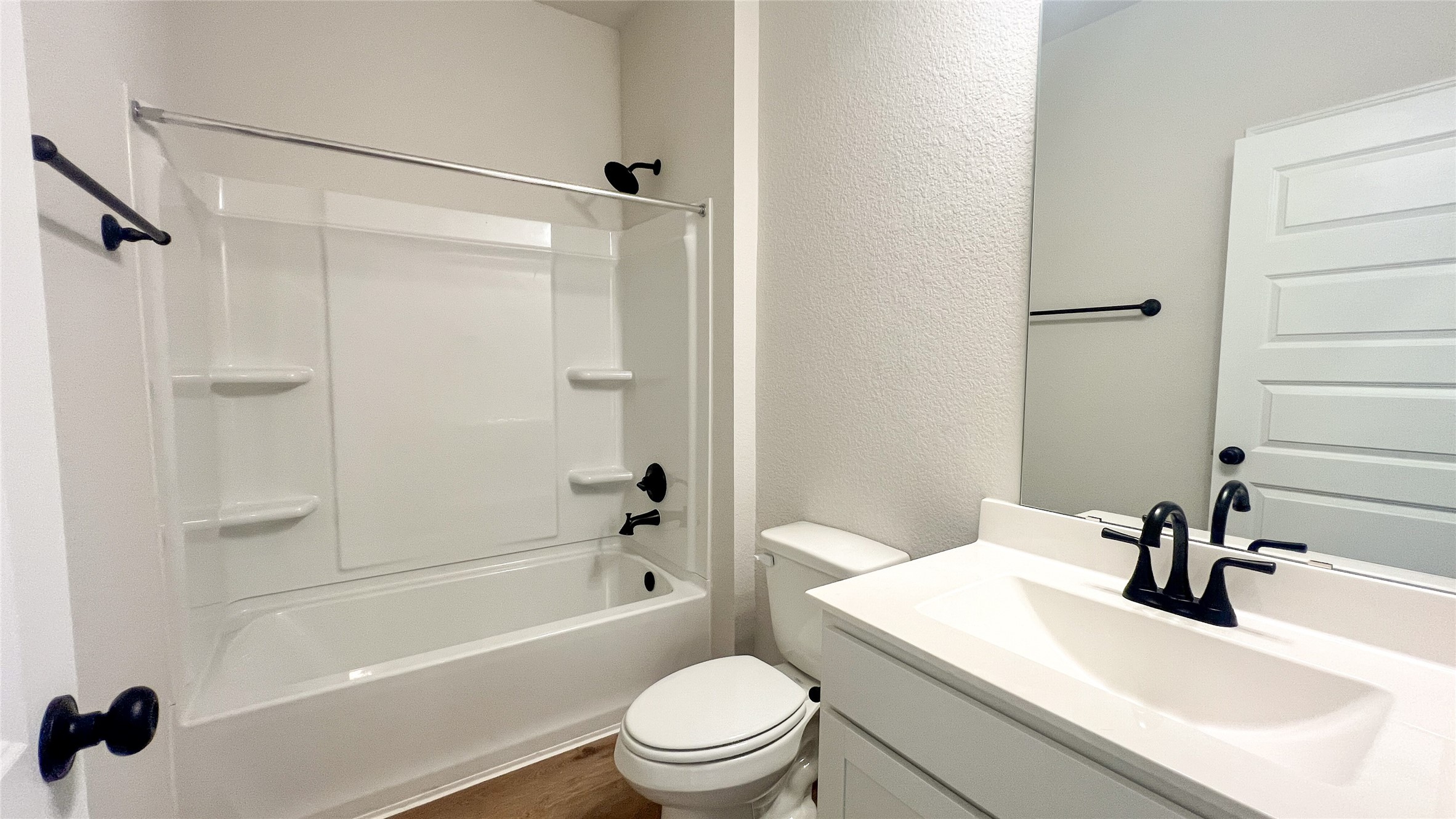 8126 Red Shiner Way Fulshear, TX 77441 - Photo 12 of 20 a bathroom with a sink a toilet and a mirror