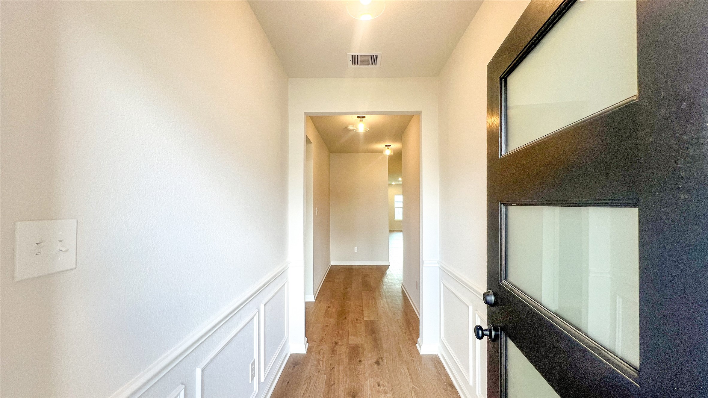 8126 Red Shiner Way Fulshear, TX 77441 - Photo 2 of 20 a view of hallway with wooden floor