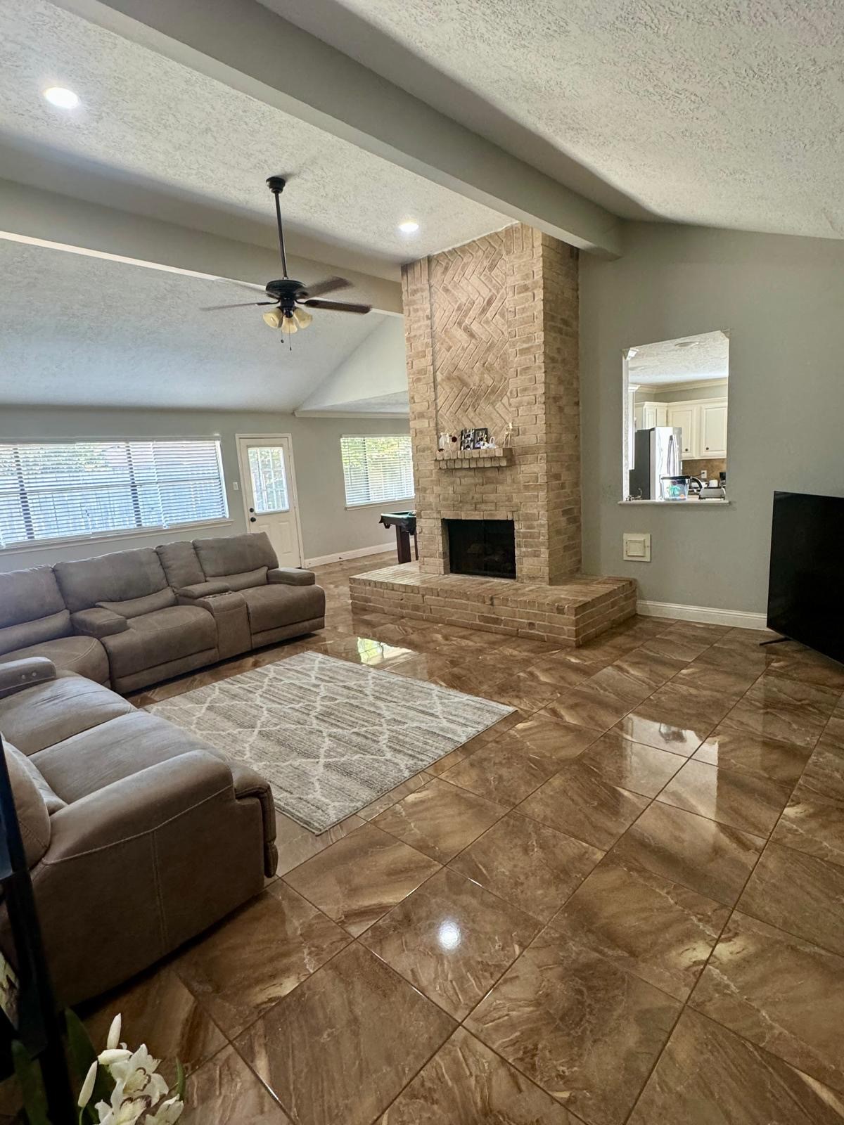 21418 Bassbrook Drive Spring, TX 77388 - Photo 15 of 29 a living room with furniture a fireplace and a flat screen tv