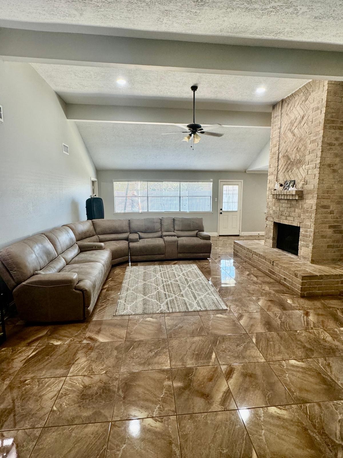 21418 Bassbrook Drive Spring, TX 77388 - Photo 16 of 29 a living room with furniture and a fireplace
