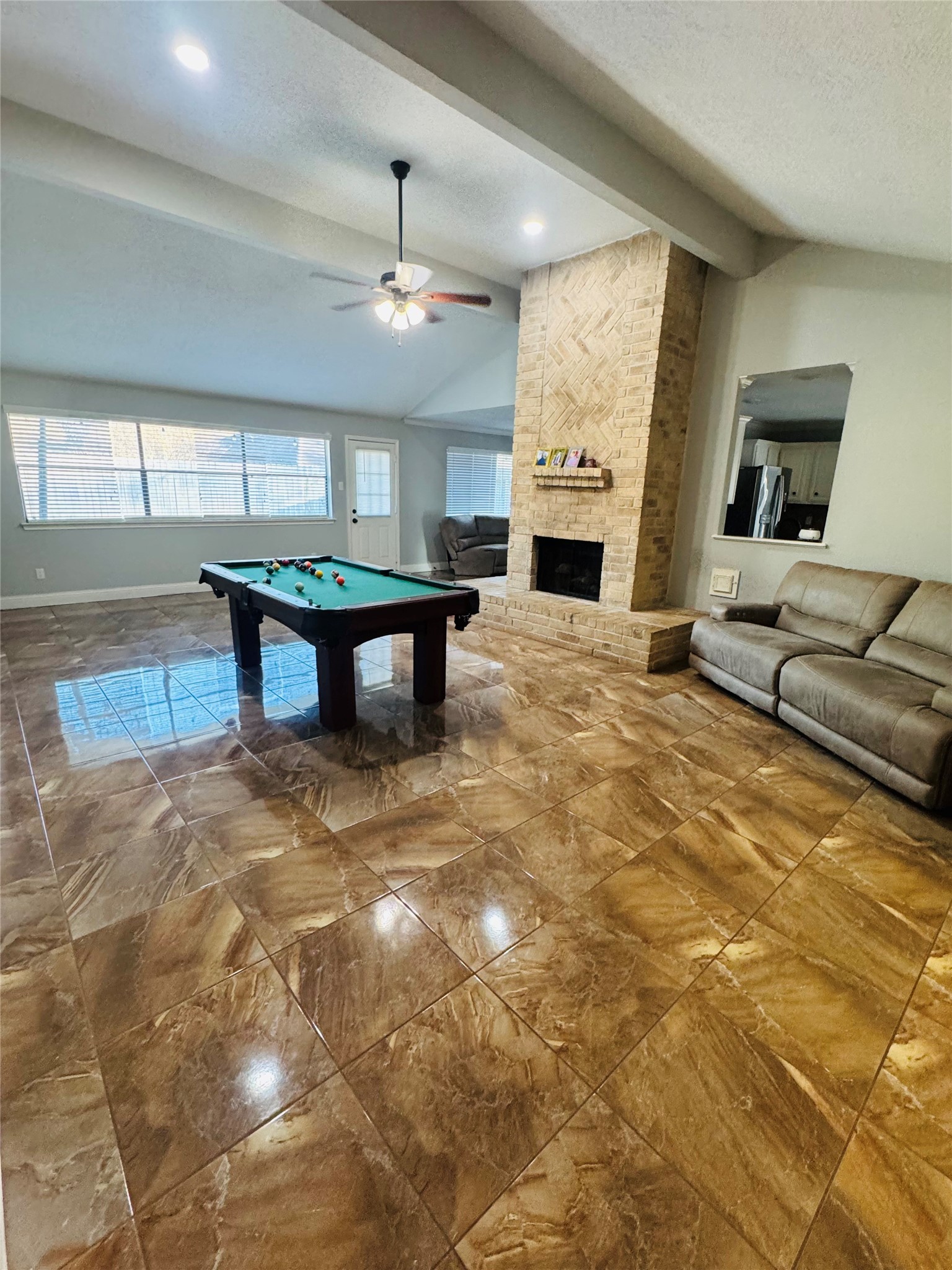 21418 Bassbrook Drive Spring, TX 77388 - Photo 20 of 29 a living room with furniture a fireplace and a chandelier