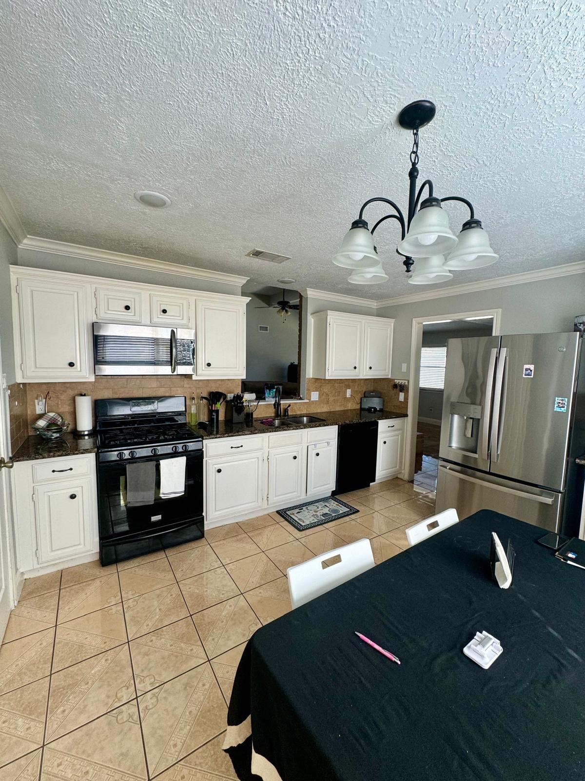 21418 Bassbrook Drive Spring, TX 77388 - Photo 8 of 29 a kitchen with stainless steel appliances granite countertop a sink dishwasher stove and white cabinets with wooden floor