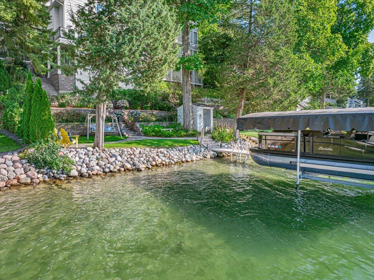 4763 Fontana Beach Road Polk, WI 53086 - Photo 48 of 61 Crystal Clear, sandy frontage. Perfectly sloped at the end of the pier. Keeping the little lake lovers safe while still being deep enough to dive off the pier!