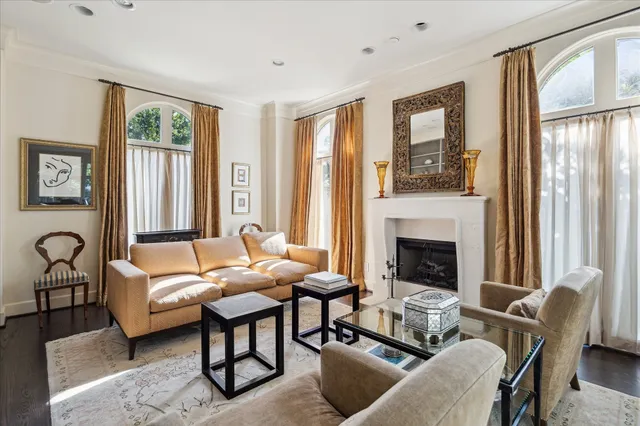 a large white kitchen with stainless steel appliances granite countertop a sink and a large window