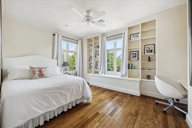 a front view of a house with a yard and an trees
