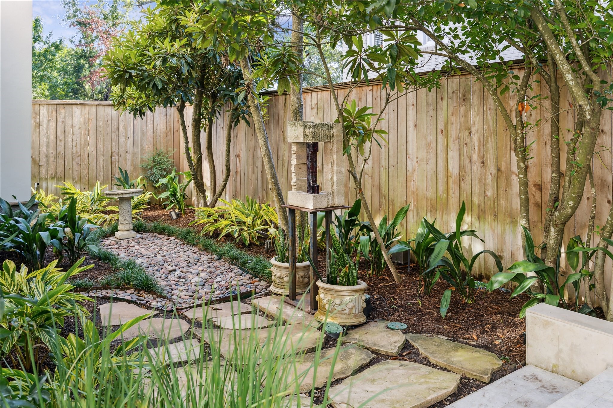 1804 Bolsover Street Houston, TX 77005 - Photo 38 of 46 a view of a backyard with potted plants and large trees