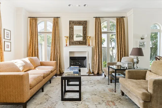 a dining room with furniture a chandelier and wooden floor