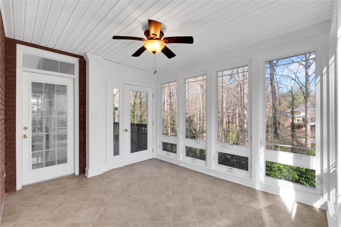 204 Red Maple Way Clemson, SC 29631 - Photo 22 of 48 This sunroom offers abundant natural light and expansive views of the surrounding natural landscape.