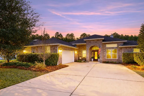 a front view of house with yard outdoor seating and barbeque oven