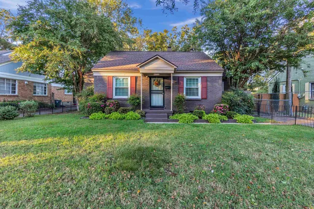 a front view of a house with garden