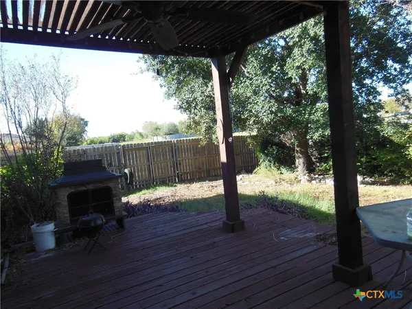 a wooden bench sitting in the middle of a yard