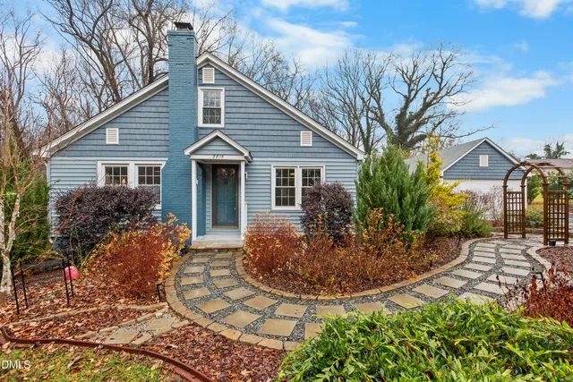 a front view of house with yard and outdoor seating