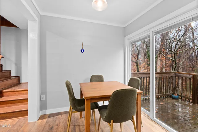 a dining room with furniture and wooden floor