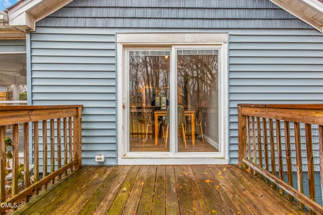 a view of a porch with a door and wooden floor