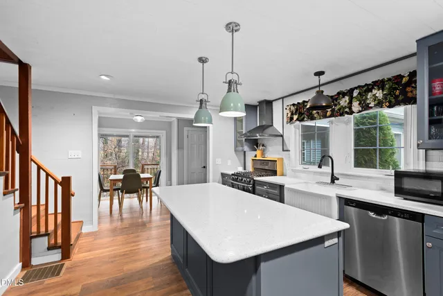 a large kitchen with sink cabinets and stainless steel appliances