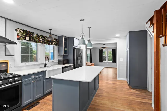 a large kitchen with granite countertop a lot of counter space and a sink