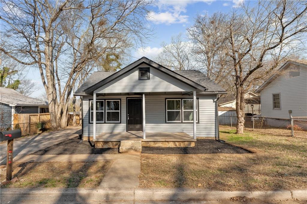 a front view of a house with a yard covered in snow