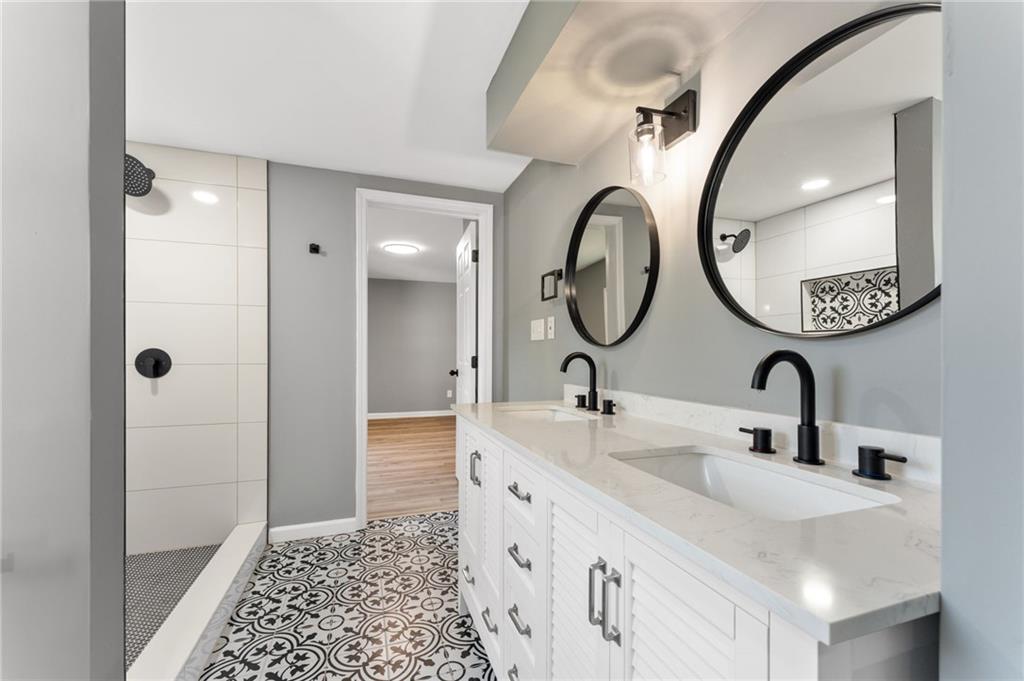 407 East 19th Street Rome, GA 30161 - Photo 12 of 17 a bathroom with a double vanity sink and a mirror