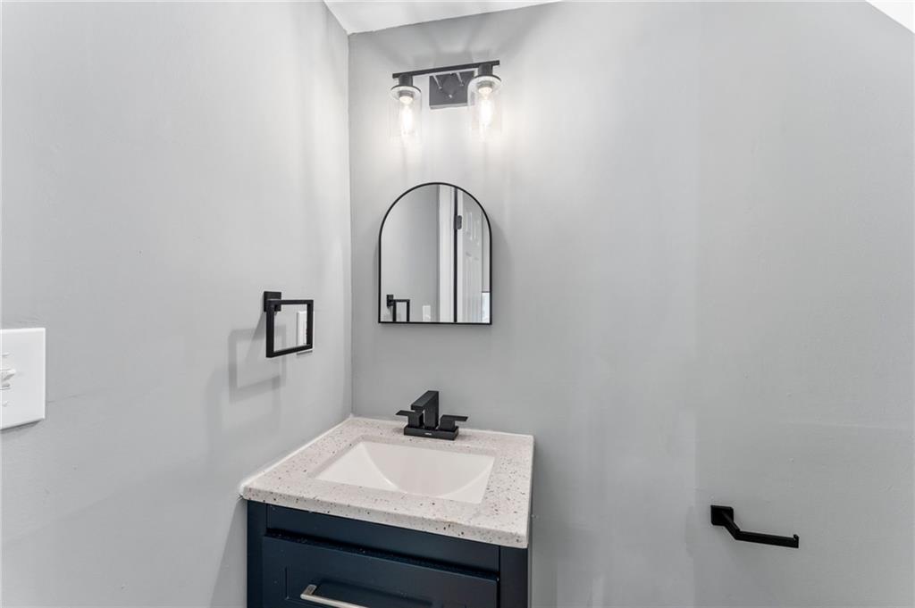 407 East 19th Street Rome, GA 30161 - Photo 13 of 17 a bathroom with a sink and a mirror
