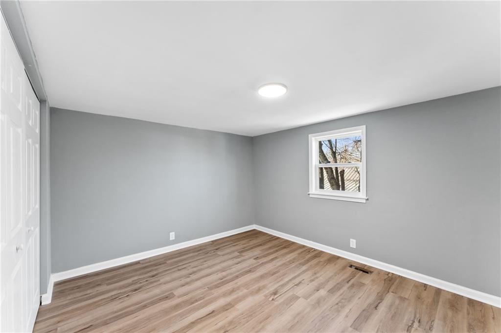 407 East 19th Street Rome, GA 30161 - Photo 14 of 17 a view of an empty room with wooden floor and a window