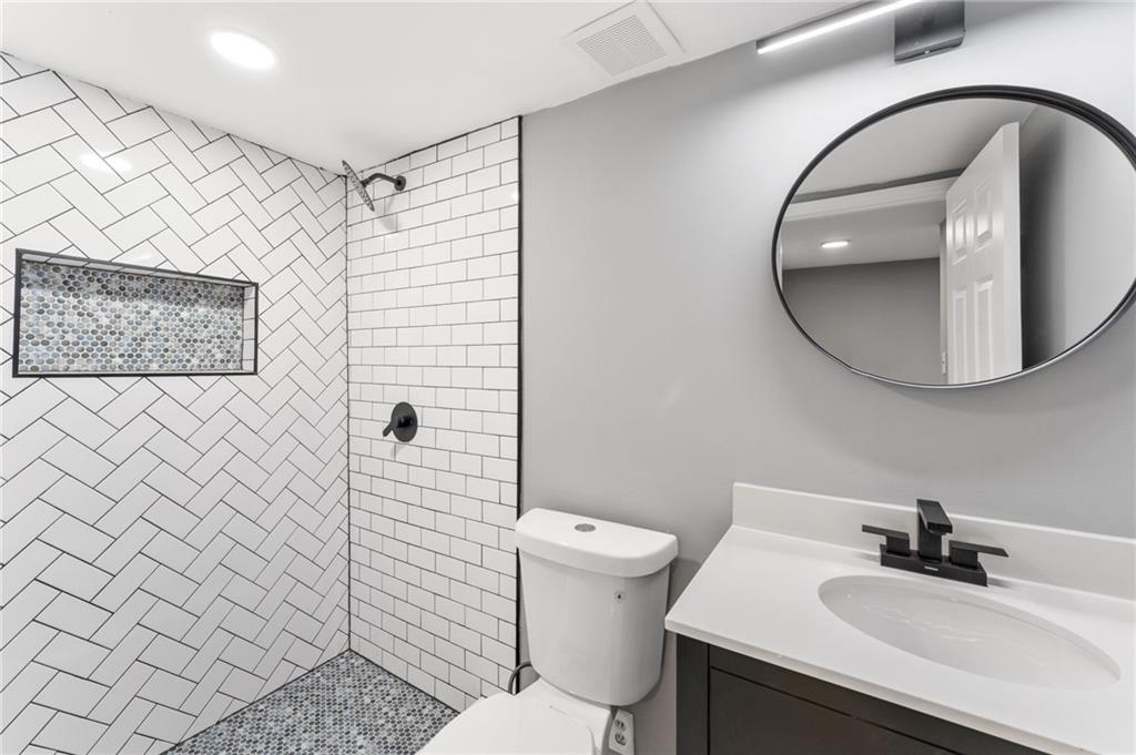 407 East 19th Street Rome, GA 30161 - Photo 15 of 17 a bathroom with a sink toilet and mirror