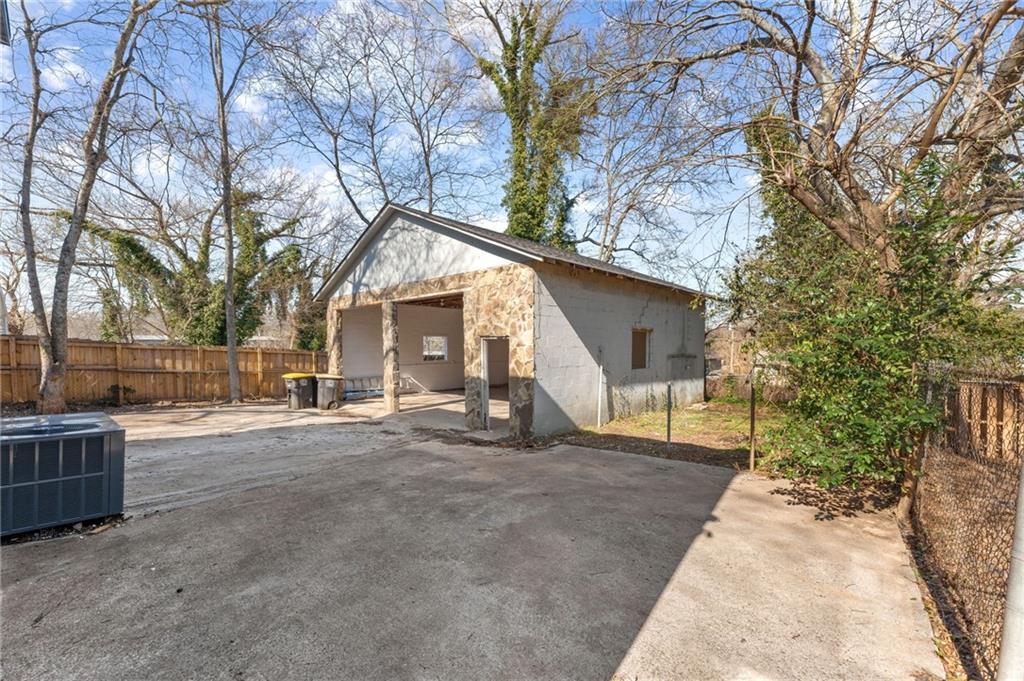407 East 19th Street Rome, GA 30161 - Photo 16 of 17 a view of a house with a large tree and wooden fence