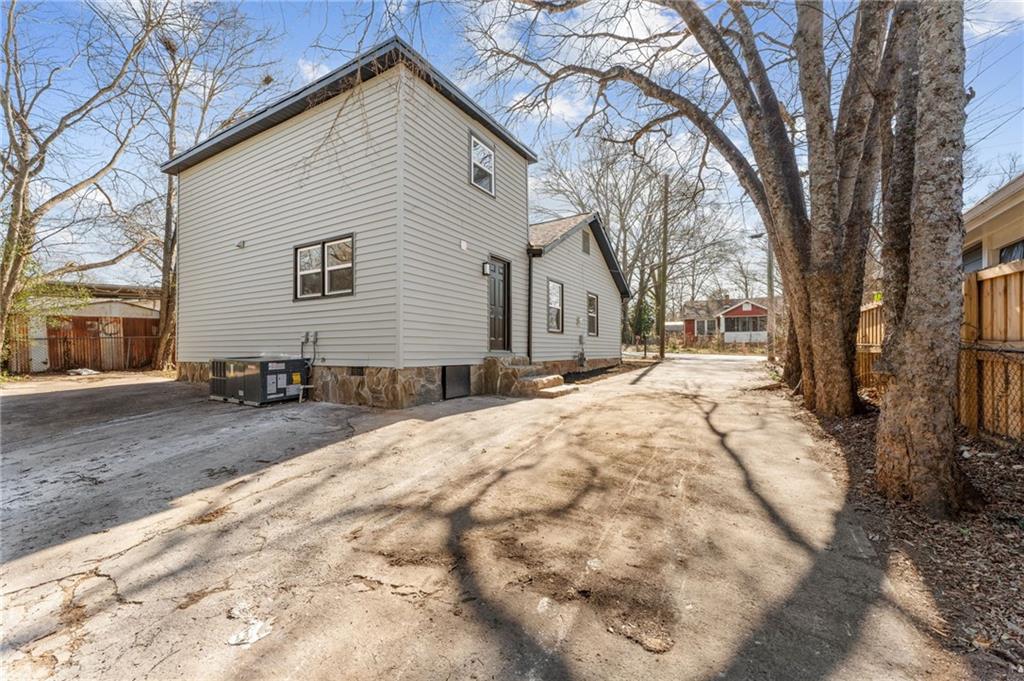 407 East 19th Street Rome, GA 30161 - Photo 17 of 17 a backyard of a house with large trees and covered with snow