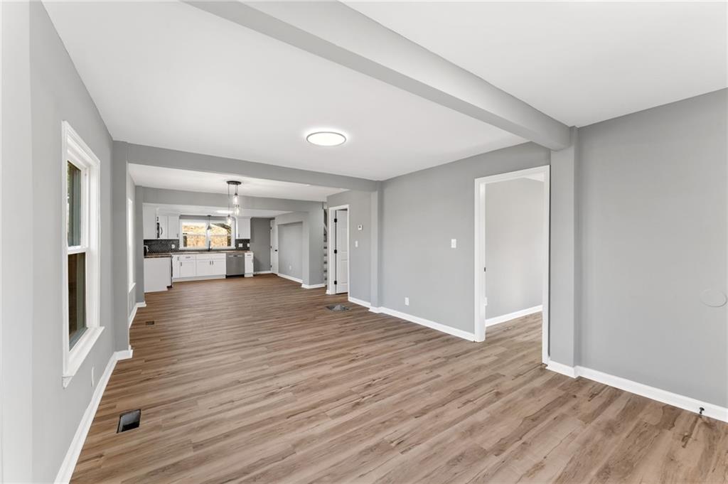407 East 19th Street Rome, GA 30161 - Photo 3 of 17 a view of a room with wooden floor and a kitchen