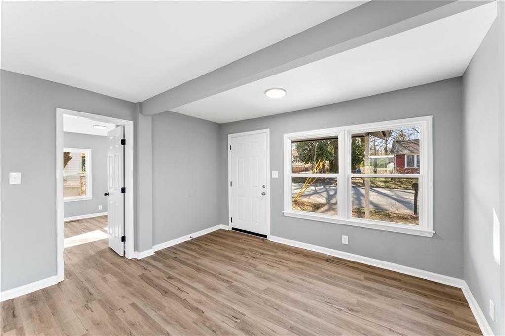 407 East 19th Street Rome, GA 30161 - Photo 4 of 17 wooden floor in an empty room with a window